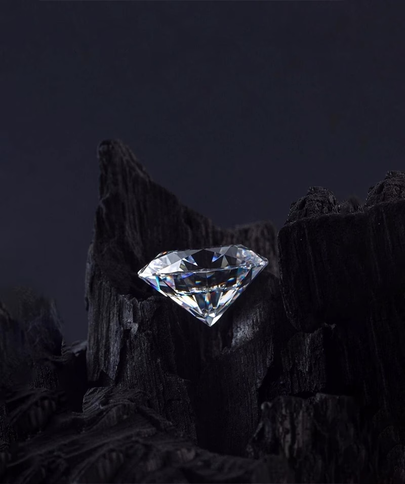 A single brilliant-cut diamond from DBT Diamonds (Diamond Board of Trade) set against a dark background.